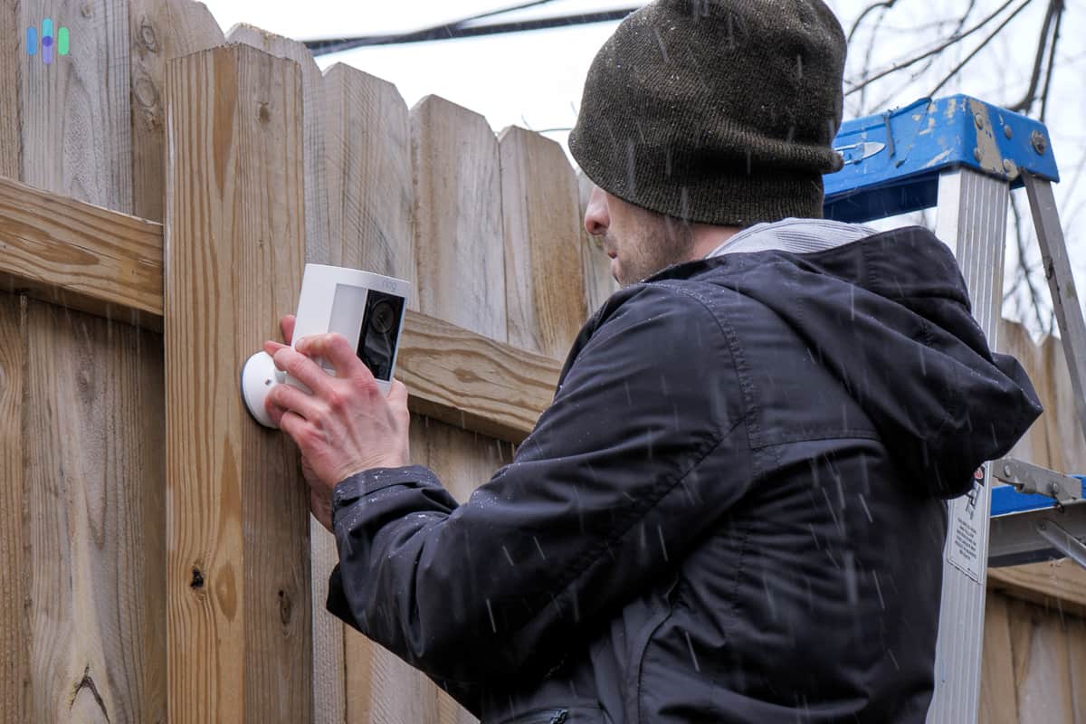 Ring Spotlight Cam Pro being mounted on a fence Ring Spotlight Cam Pro being mounted on a fence